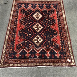 Persian style red and blue ground rug, three central diamonds, repeating border, 220cm x 165cm