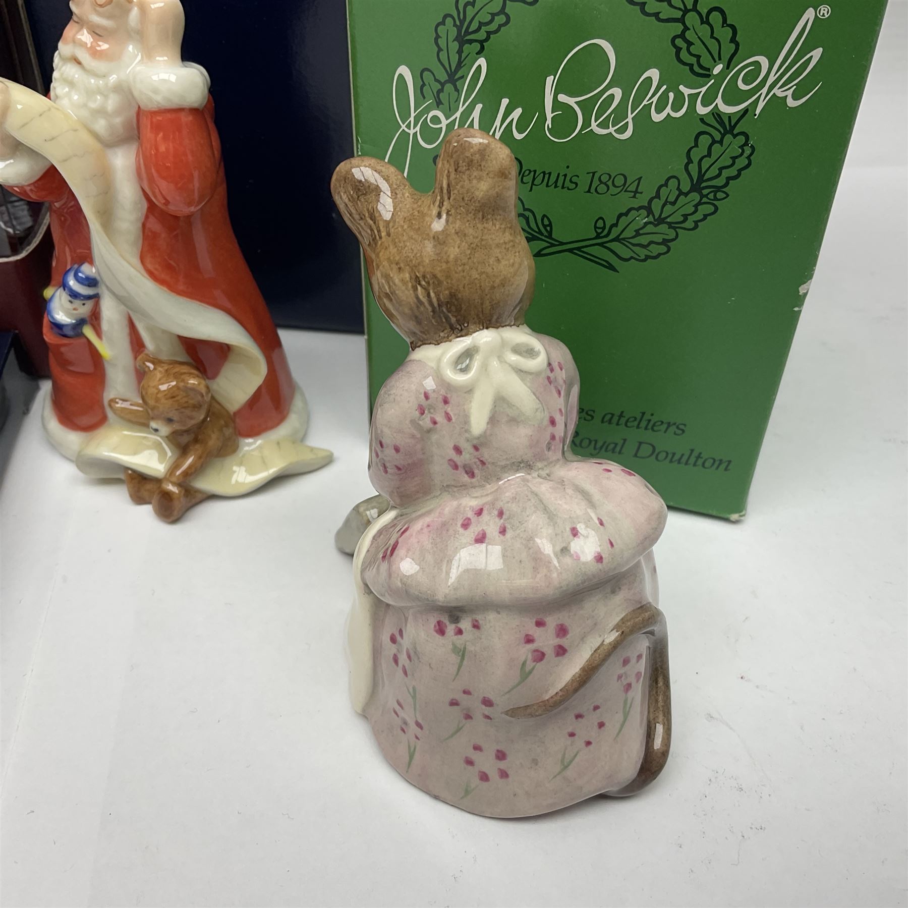 Two Royal Copenhagen figures, comprising Julie and Girl with Saw, together with Beswick Hunca Munca Sweeping, and two Villeroy & Boch christmas decorations, all with original boxes   