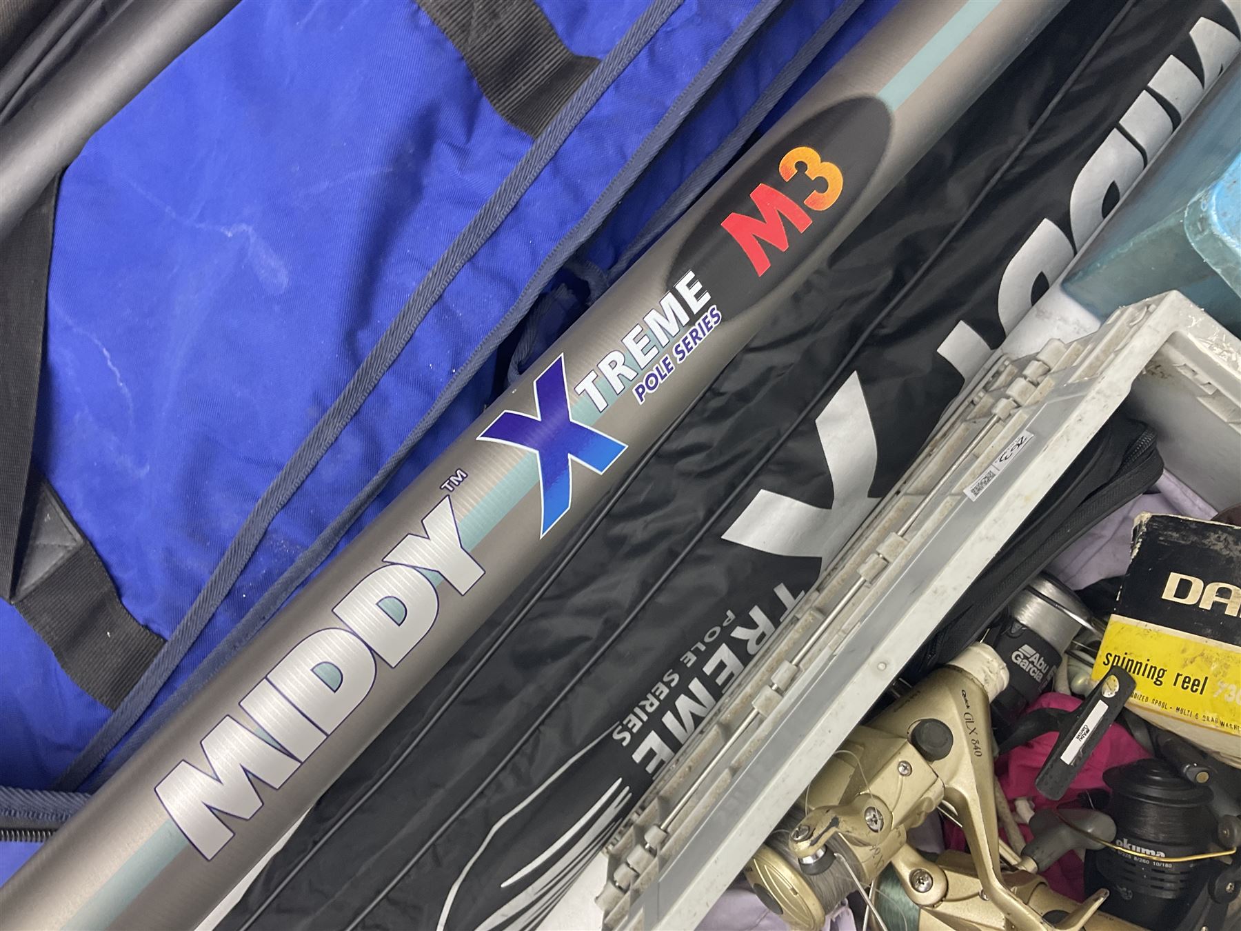 Fishing equipment, comprising reels to include Daiwa No.7300, boxed, Quick GLX 840, Quantum Heat BCS 350, okuma etc, together with various tackle, various poles, split canes and rods to include Middy Xtreme, Shakespeare Quo Carp, etc, many in bags