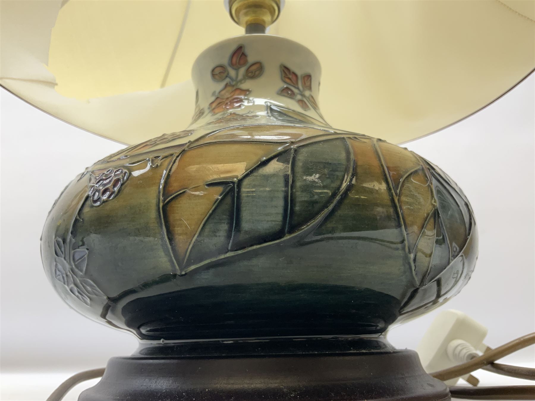 Moorcroft table lamp of squat baluster form, decorated in the Autumn Blackberry, with Moorcroft cream fabric shade with gold, green and red piping, overall H38cm