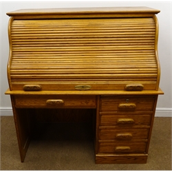  Colonial oak single pedestal shaped roll top desk, fall front frieze drawer with keyboard slide and single cupboard door enclosing fitted interior on plinth base (W123cm, H132cm, D74cm) with an oak swivel chair, turned and carved splat, upholstered seat (W55cm)  