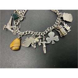Silver charm bracelet, with eighteen charms, including cottage, shamrock, golf bag, giraffe, cow and witch, etc 