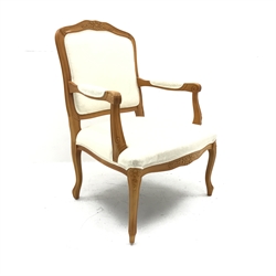 French style beech framed armchair, carved and shaped cresting rail, upholstered back, seat and arms, cabriole legs, W69cm 