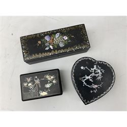  Late 19th / early 20th century Japanese lacquered table top cabinet, heavily decorated with mother of pearl inlay depicting blossoming branches, flowers and birds, the two hinged doors between longer drawers opening to reveal interior fitted with four short drawers, with lift up hinged canted lid, H28cm D9.5cm W23cm, together with mother of pearl inlaid miniature folding screen, dish decorated with walking figures with crimped edge, boxes decorated with flowers, birds and gilt etc