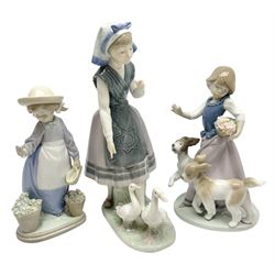 Three Lladro figures, comprising Out for a Romp, no 5761, Aracely with Ducks, no 5202, and Hello, Flowers, no 5543, all with original boxes, largest example H25cm