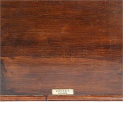 Edwardian Asprey mahogany desktop book trough, the segmental arched back with inlaid fan patera and serpentine shaped sides, above single recess and moulded base rail, housing Asprey & Co Ltd leather bound reference library, comprising Dictionary, French and English Dictionary, English Quotations and Proverbs, Classics and Mythology, Encyclopedia, French and Latin Quotations, Gazetteer, and Atlas, book trough, 22cm x 22.5cm x 11cm
