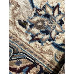 Persian Kashan ivory ground carpet, central rosette medallion surrounded by swirling leafy branches and floral sprays, the main border with scrolling pattern interspersed with floral motifs, within guard stripes 