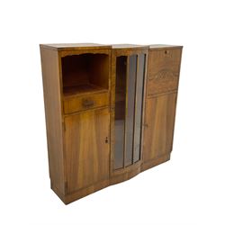 Early 20th century walnut side cabinet, enclosed by central bowed and glazed door, fitted with drawer, two cupboards and fall front, on plinth base