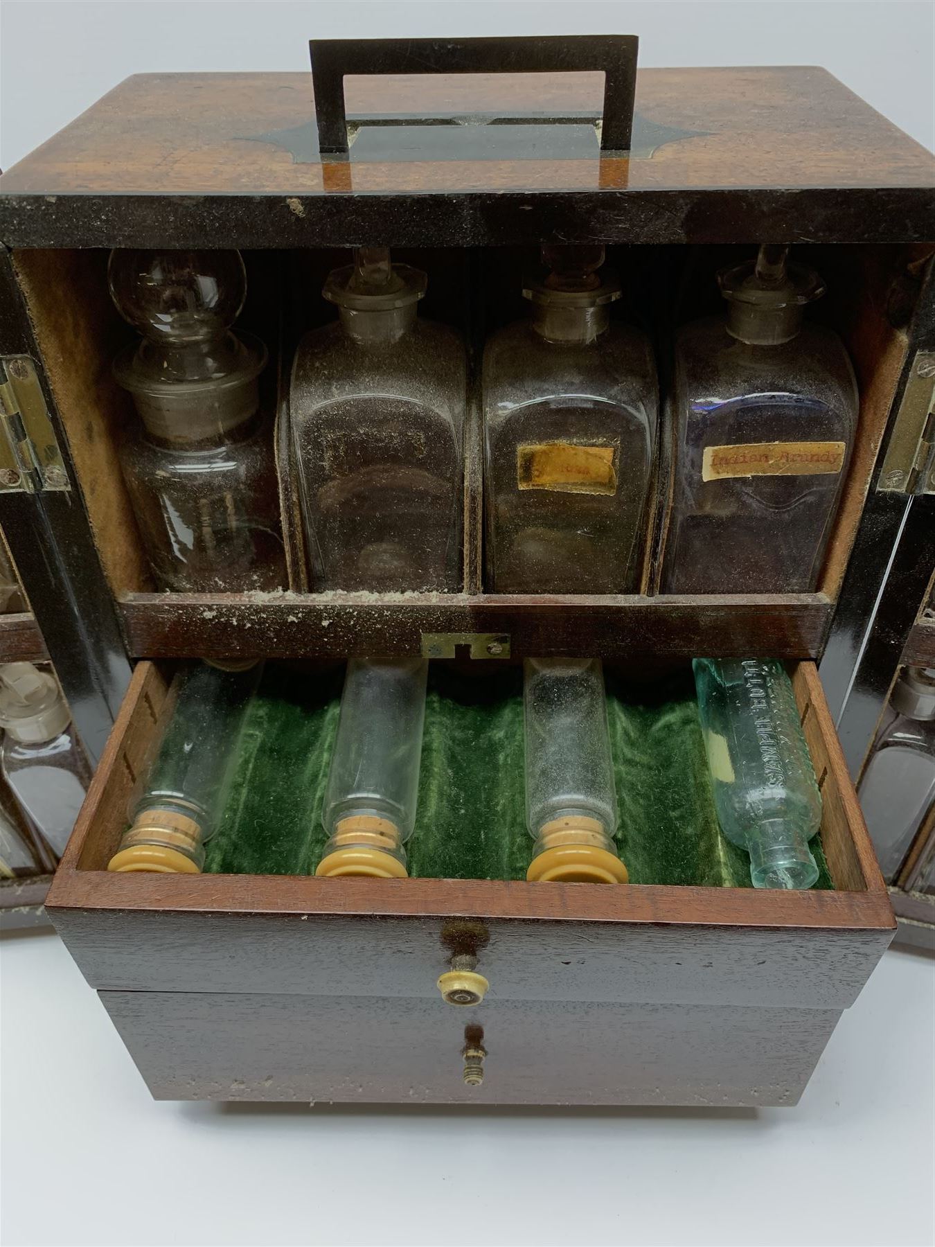 19th century mahogany travelling apothecary cabinet, with recessed brass carry handle to top, and two deep-section hinged doors to the front opening to reveal a fitted interior with clear glass bottles and two drawers, H27cm