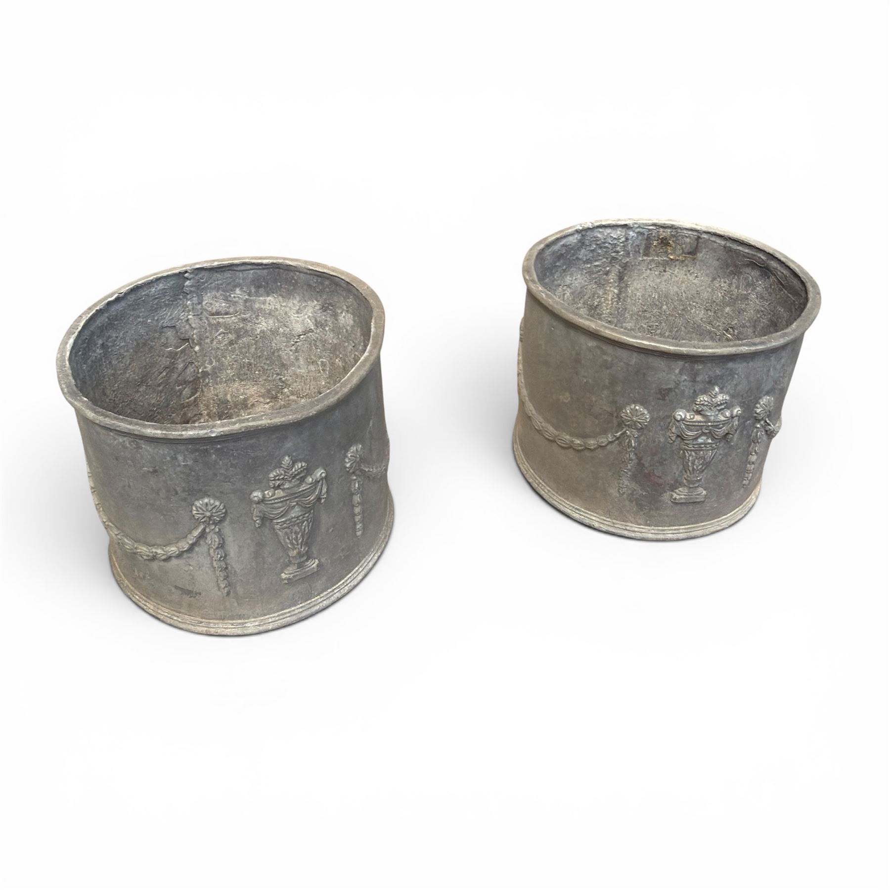 Pair of 19th century Neoclassical design lead garden planters of cylindrical form, the body decorated with an ornate central urn with swags and foliate design, flanked by festoons of bellflowers with roundel motifs