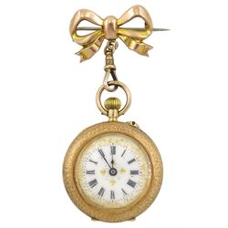 Gold open face ladies keyless cylinder fob watch stamped K14, white enamel dial with Roman numerals and gold decoration, on gold bow brooch stamped 9ct