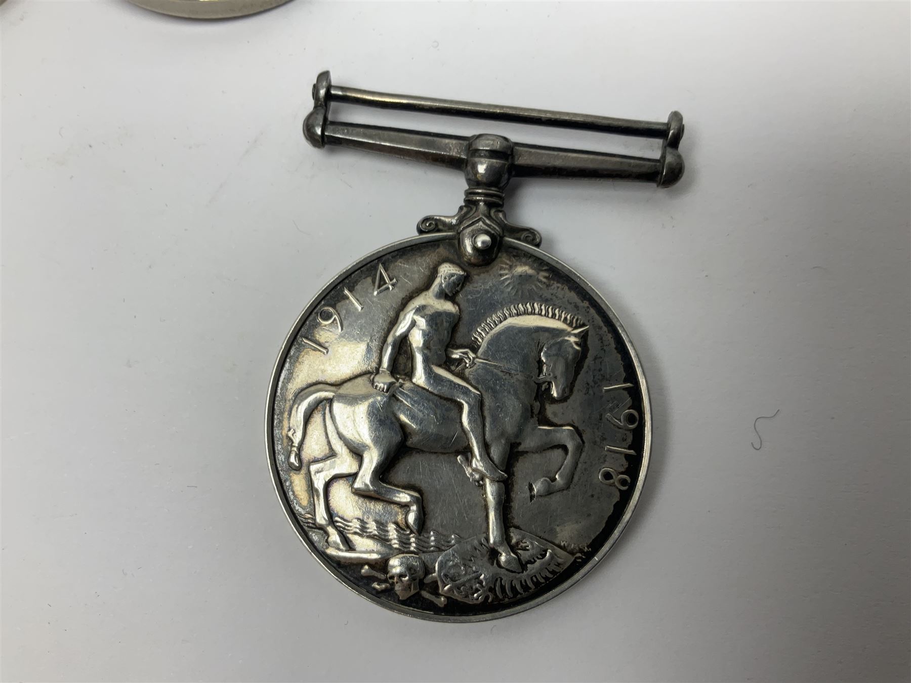 WWII group of five medals comprising 1939-45 War Medal, Defence Medal, 1939-45 Star, Africa Star and France and Germany Star on wearing bar; WWI British War Medal awarded to 142019 Pte. A. Thompson A.S.C.; and boxed King's Badge 'For Loyal Service'