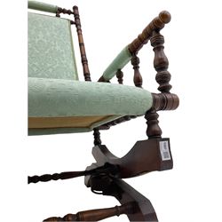Early 20th century walnut framed American rocking chair, upholstered seat, back and arms