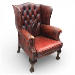 Georgian design wingback armchair upholstered in oxblood leather, the deep button upholste...