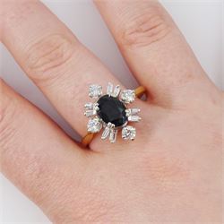 18ct gold sapphire and diamond cluster ring, single oval cut sapphire of approx 1.65 carat, surrounded by four round brilliant cut diamonds and eight baguette cut diamonds, London 1975, total diamond weight approx 0.60 carat