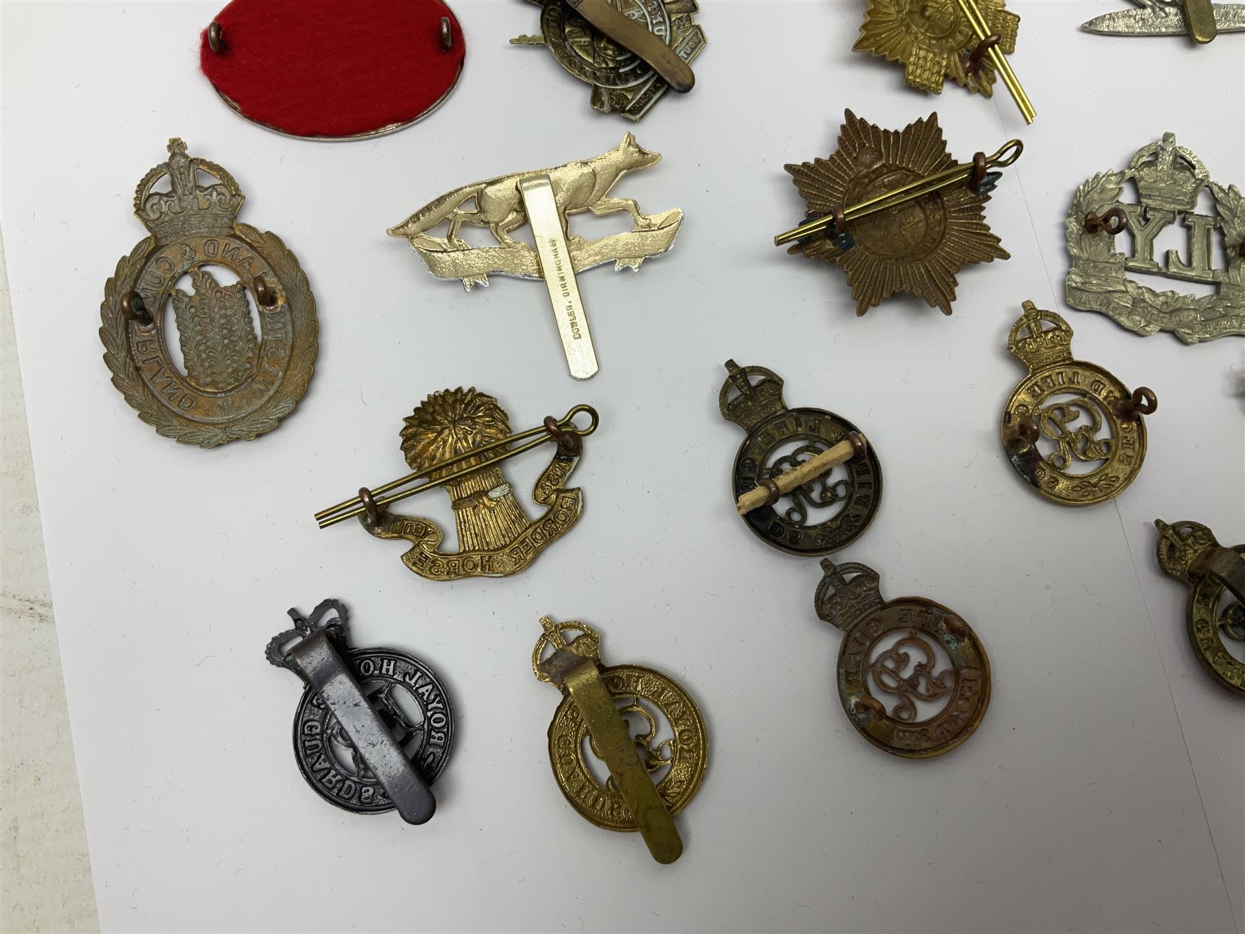 Twenty-six cap badges for Yeomanry and various guards including Fife & Forfar, Lothian and Border Horse, Leicestershire, Northamptonshire, Queens Own, Coldstream, Grenadier, Machine Gun Regiment, Life Guards etc (26)