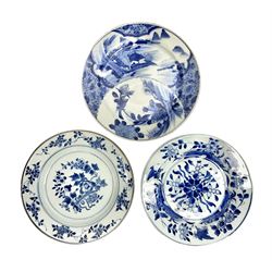  Japanese Meiji period Arita blue and white plate, of circular form, painted with riverside landscape and bird upon flowering branch, with character mark beneath, D24.5cm, together with two 18th century Chinese blue and white plates, each painted with floral design, each approximately D22.5cm