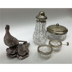 Contemporary filled silver ornament in the form of a cock and hen pheasant, hallmark Sheffield 2014, makers mark indistinct,  cut glass shaker with silver cap and collar, J H Hillcox Birmingham 1915, two cut glass salt cellars with silver collars, Birmingham 1901 makers mark indistinct, glass jar with silver collar, handle and lid, Martin, Hall & Co (Richard Martin & Ebenezer Hall) Sheffield 1900 . 