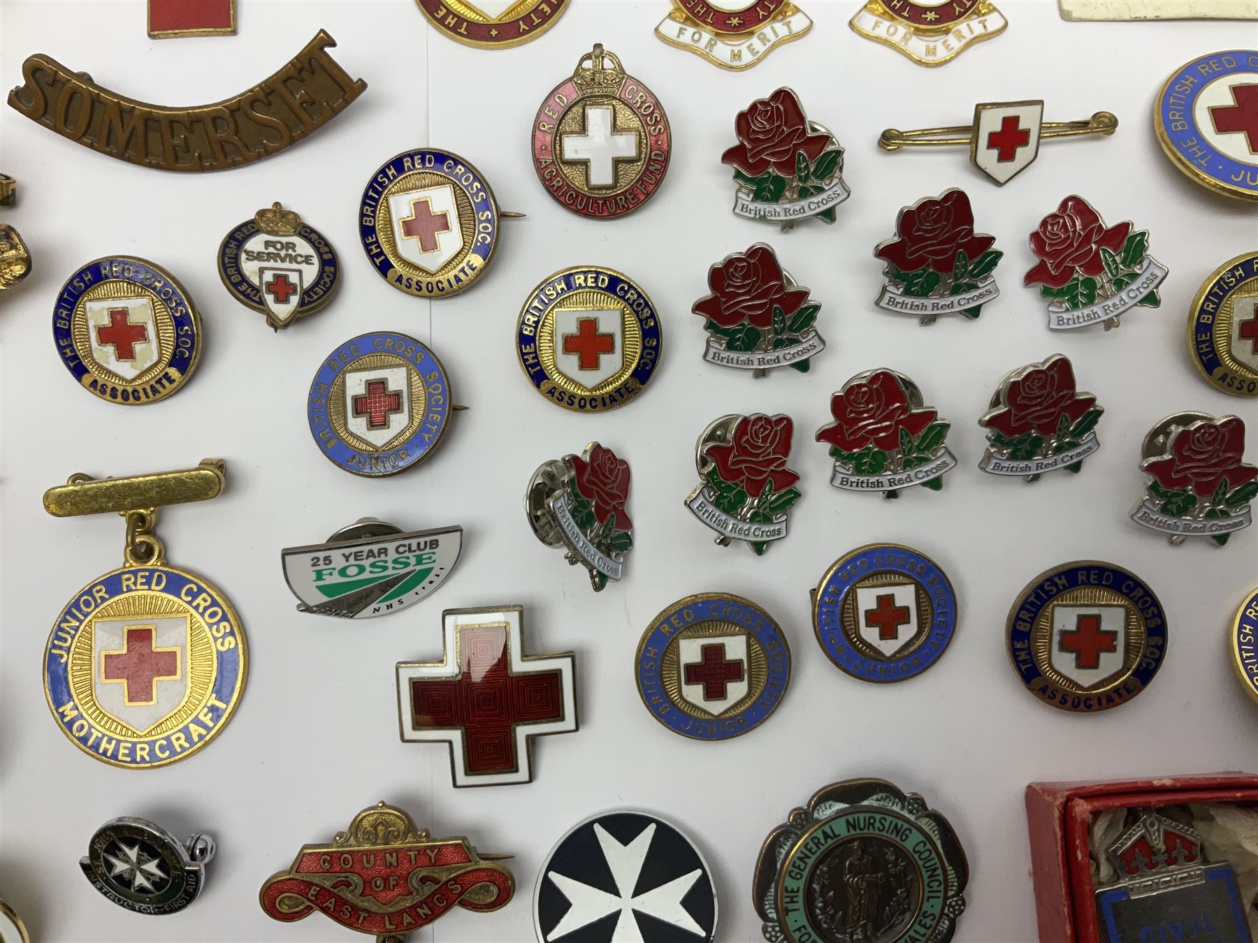 Collection of St John Ambulance enamel and metal badges, together with Red Cross medals and badges