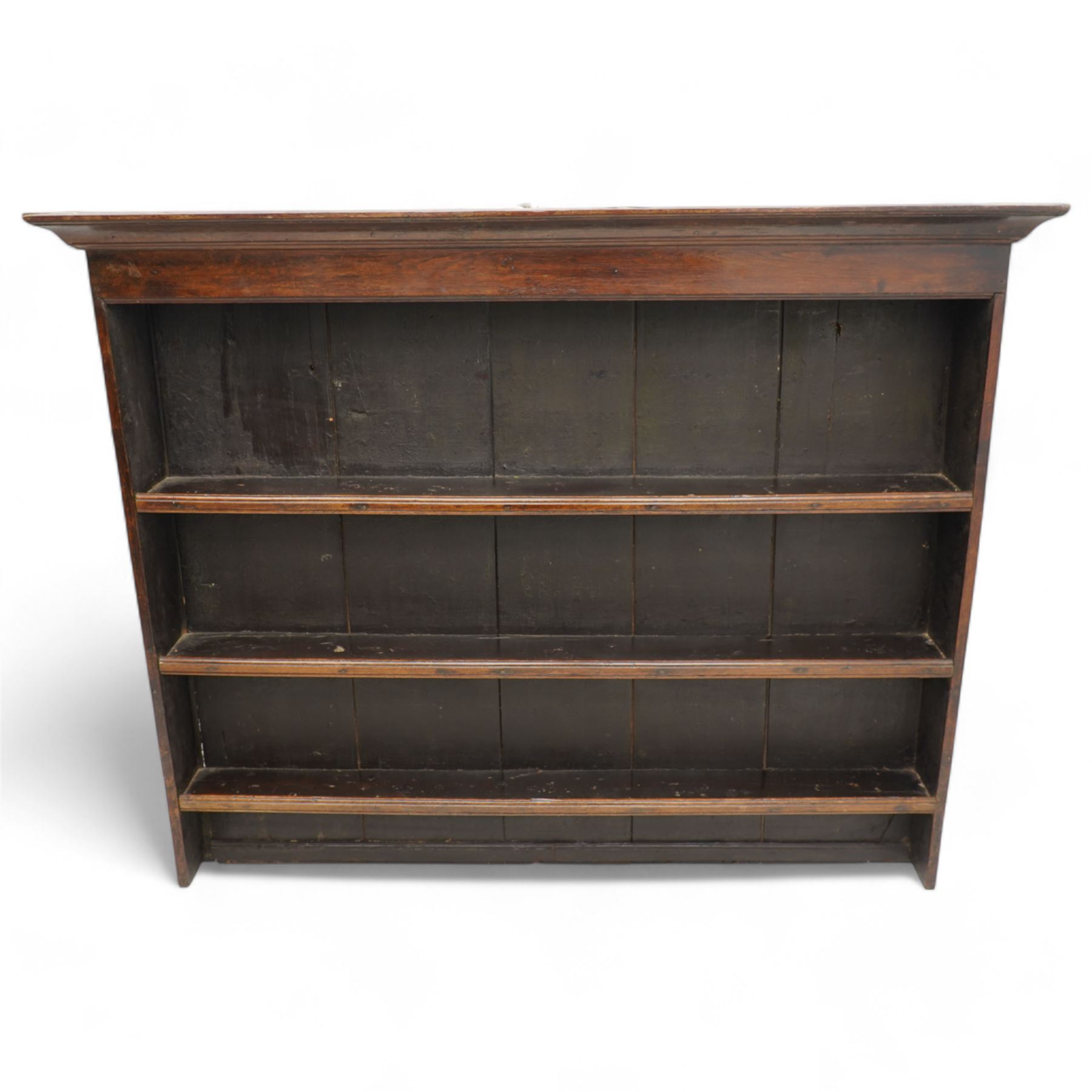 18th century oak plate rack, moulded projecting cornice over three shelves, on solid end supports 