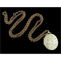 Gold locket pendant with engraved decoration, on gold rope twist necklace, both hallmarked 9ct 