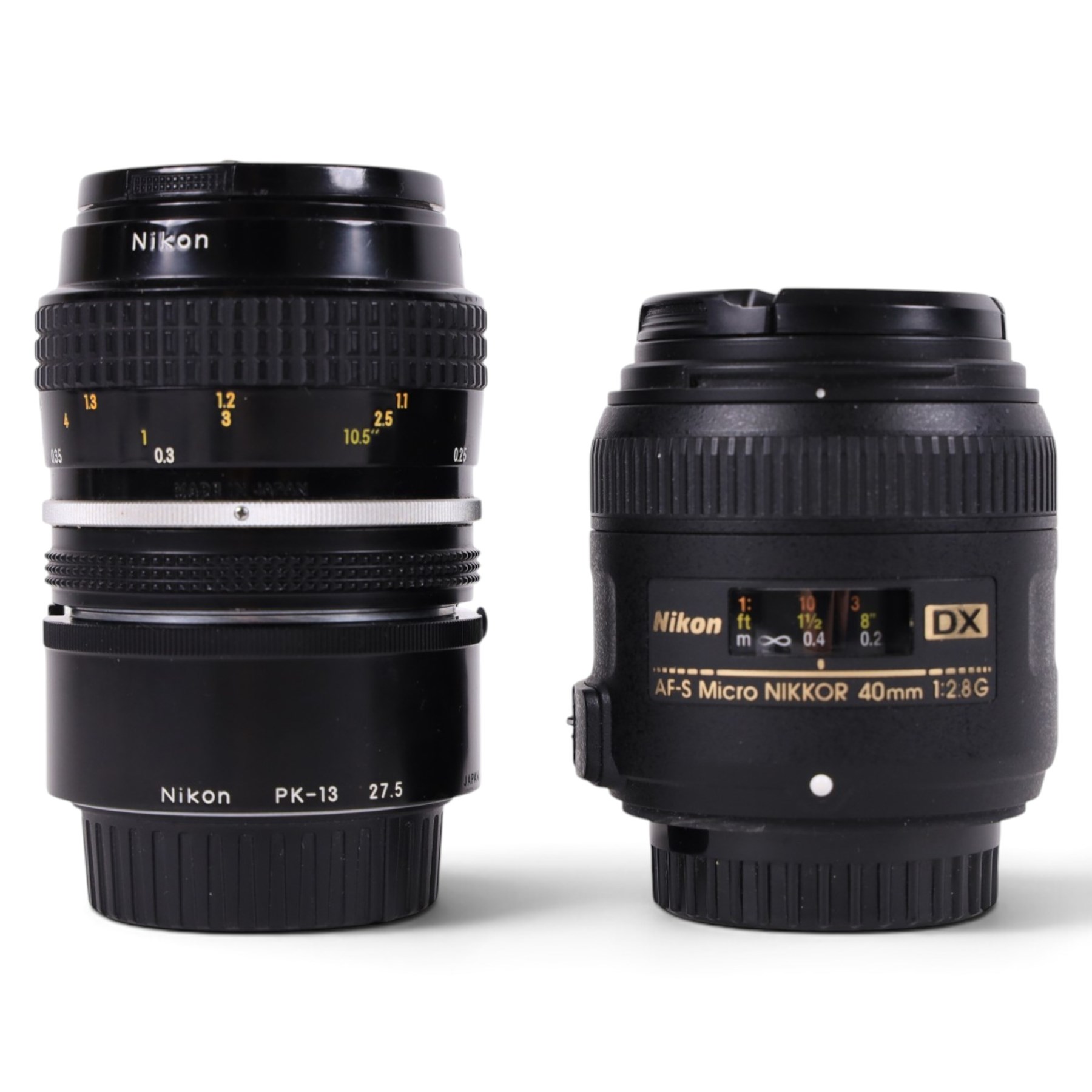 Two Micro-Nikkor camera lenses, comprising AF-S DX 40mm 1:2.8G with user manual, serial no. 2055767 and a 55mm 1:3.5 serial no. 1051782