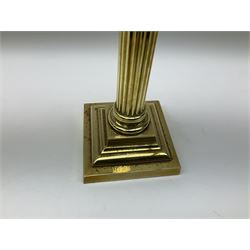 Victorian brass oil lamp, the square stepped base leading to a Corinthian column supporting a part slice cut clear glass reservoir, burner, clear glass chimney and foliate etched glass shade with amber rim, overall H80cm