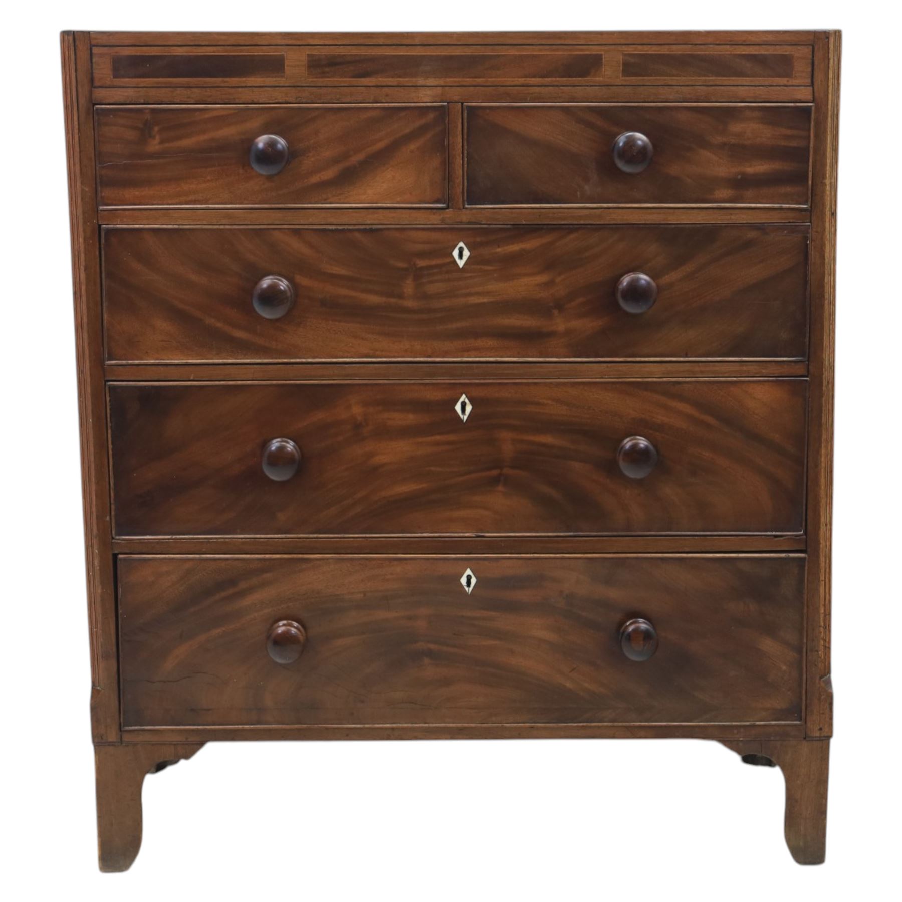 Early 19th century mahogany chest, straight front with canted corners, featuring inlaid detail above two short and three long drawers with flame veneered facias
