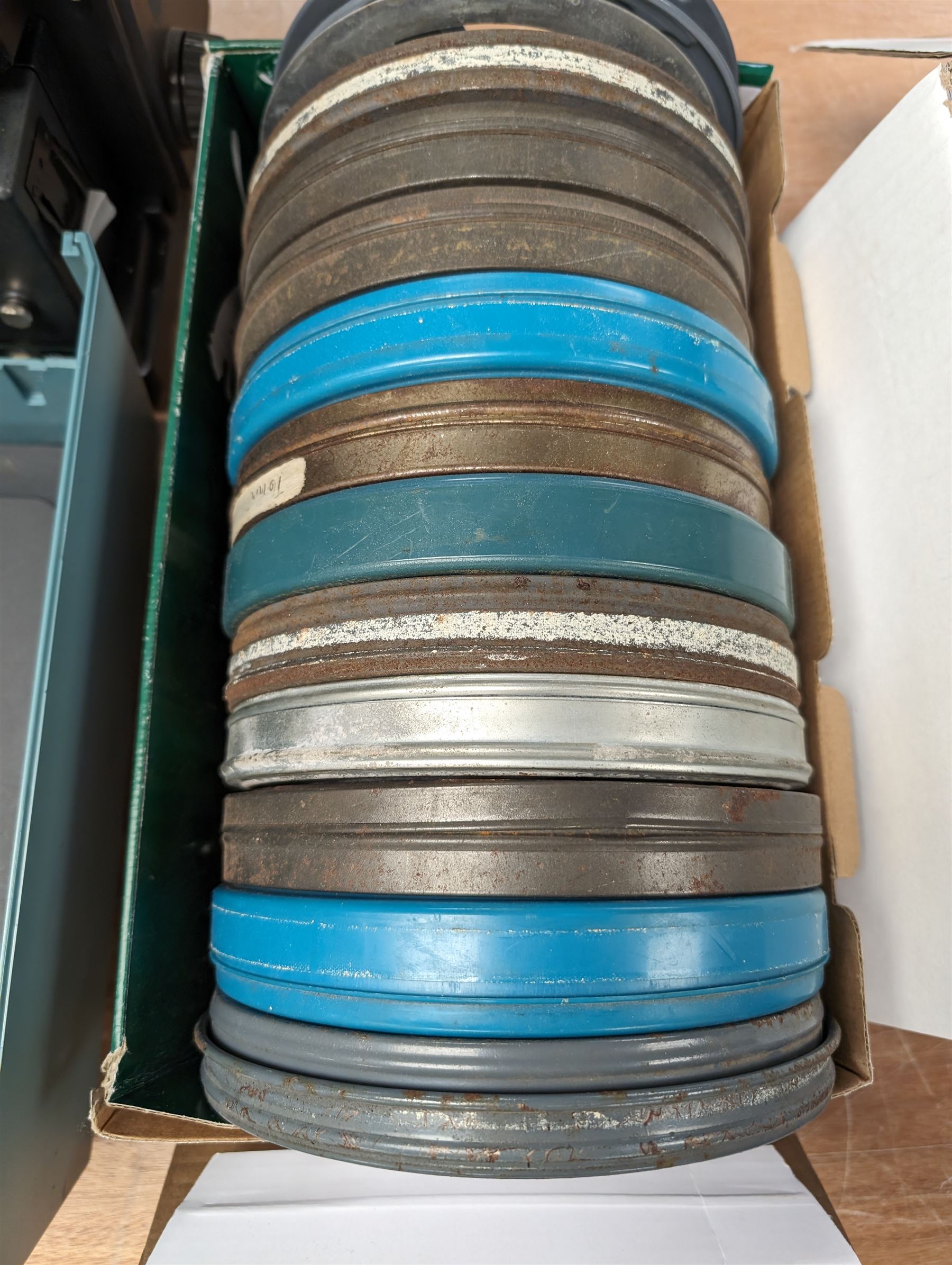 Bell & Howell TQ III 16mm film projector, together with lenses and spare projector lamps and a quantity of 16mm film reels, including Kellogg advert, Tex Avery cartoon and other film reels