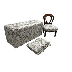 Ottoman blanket box upholstered in floral pattern fabric, matching bedroom chair and curtains