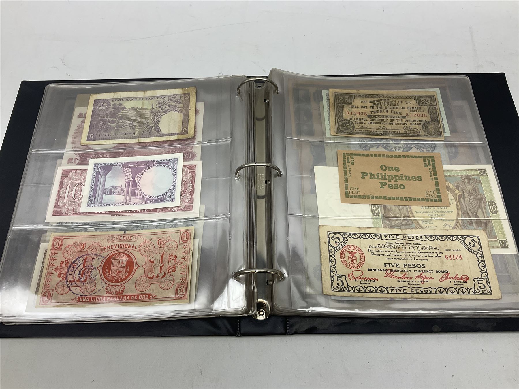 World banknotes, including Queen Elizabeth II The States of Jersey one pound 'DB202703', five pounds 'BB527762' and ten pounds 'AB651481', reserve bank of New Zealand two dollars '1L3 741894', King George V Straits Settlements one dollar 1st January 1935 'F/83 28924', various Bank of England notes etc, housed in two ring binder albums