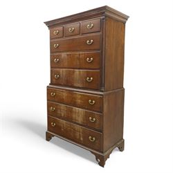 Mid 18th century oak tallboy chest, the projecting cavetto-moulded cornice over two short and three long drawers to the upper section, the lower section with three further graduated long drawers, each drawer with oak linings and fitted with later brass swan-neck handles, flanked by stop-fluted quarter columns, all raised on shaped bracket feet