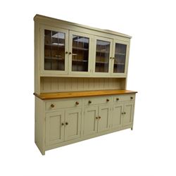 Traditional pine dresser, raised display cabinet enclosed by four lead glazed doors, polished rectangular top over three drawers and three panelled double cupboards