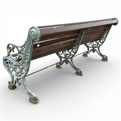 Victorian cast iron garden bench with dark wooden slats and ornate green painted ends.