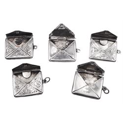 Five early 20th century silver stamp holders modelled in the form of envelopes, comprising three foliate engraved examples, and two plain examples, one with applied detail 'Stamps' verso, hallmarked Albert Ernest Jenkins, (makers mark to one example worn and indistinct),  Chester 1904, 1906, 1908 and 1912, approximate total weight 0.60 ozt (18.6 grams)