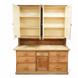 Early 20th century pine and beech kitchen dresser, projecting cornice above three panelled cupboard doors, base fitted with three drawers and twin panelled cupboards, on plinth base