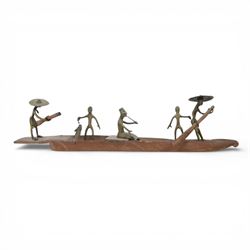 Dahomey Benin style sculpture, modelled as a wooden fishing boat with bronze figures, L41cm, H10cm