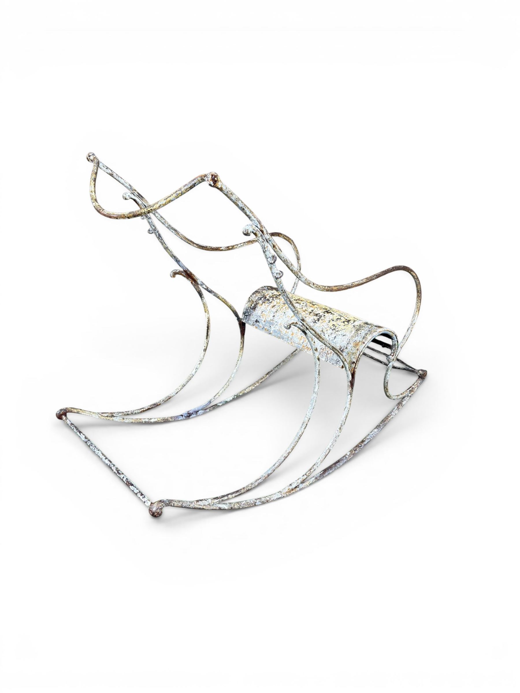 Pair of white painted cast metal garden chairs, ornate reclined backs, circular pierced seats on cabriole legs