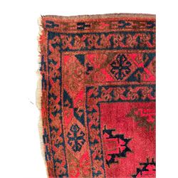 Persian red ground rug, the field decorated with all-over geometric medallions, multi-band border with repeating lozenges 