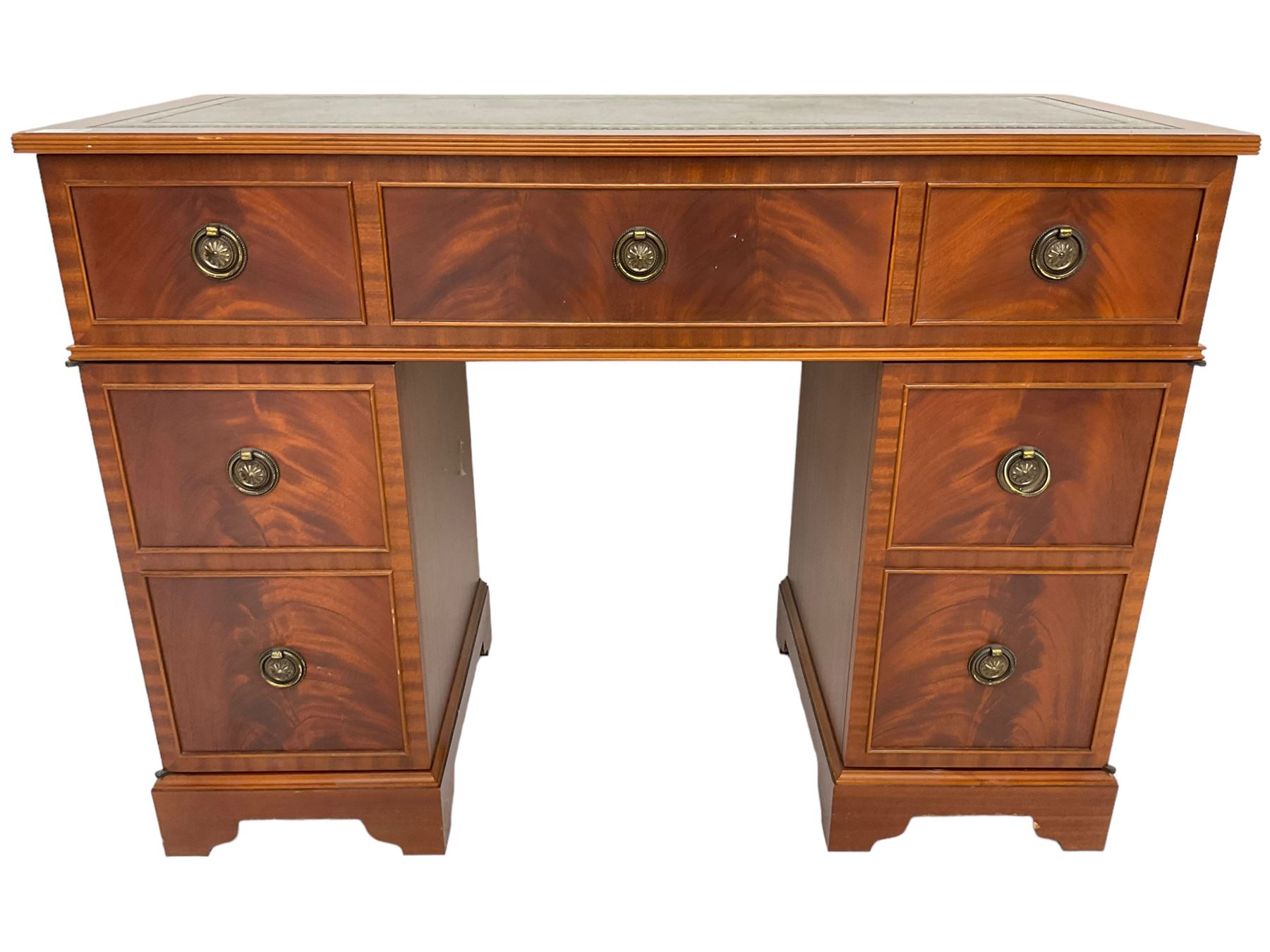 Music system in the form of a Georgian design twin pedestal desk, the reed moulded rectangular top hinges to reveal Garrard turntable with Dynatron Amplifier, fitted with speakers enclosed by two doors disguised as drawers, on bracket feet