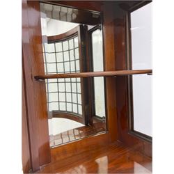 Late Victorian walnut mirror back sideboard or dresser, the raised back fitted with two curved and lead glazed cabinets, central arched bevelled mirror, the sideboard with break bowfront, fitted with six drawers and two cupboards, the cupboard doors panelled and carved with scrolls, shell and plant motifs, shaped apron with cabriole feet
