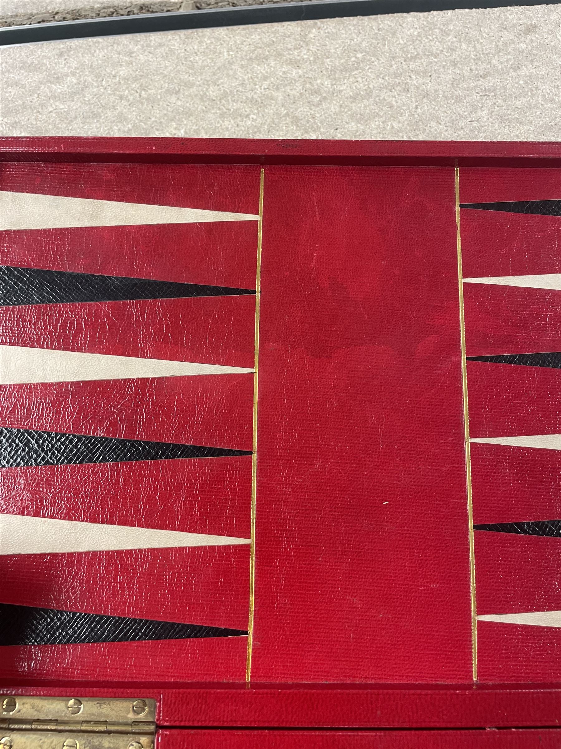 19th century walnut and brass bound games compendium box, painted to enhance the grain, of rectangular form, the hinged opening cover with rounded sides, central brass cartouche with engraved lion crest, and brass riveted straps, opening to reveal a red leather and blue silk lined compartmented interior, with fold-down games board, and lift-out tray containing playing cards, ebony turned dice towers, white and red stained bone draughts, and chess pieces, ivory dice, and ivory and ebony whist markers, and brass bezique board, cribbage board and markers, H15cm W32cm D24cm
This lot has been registered for sale under Section 10 of the APHA Ivory Act