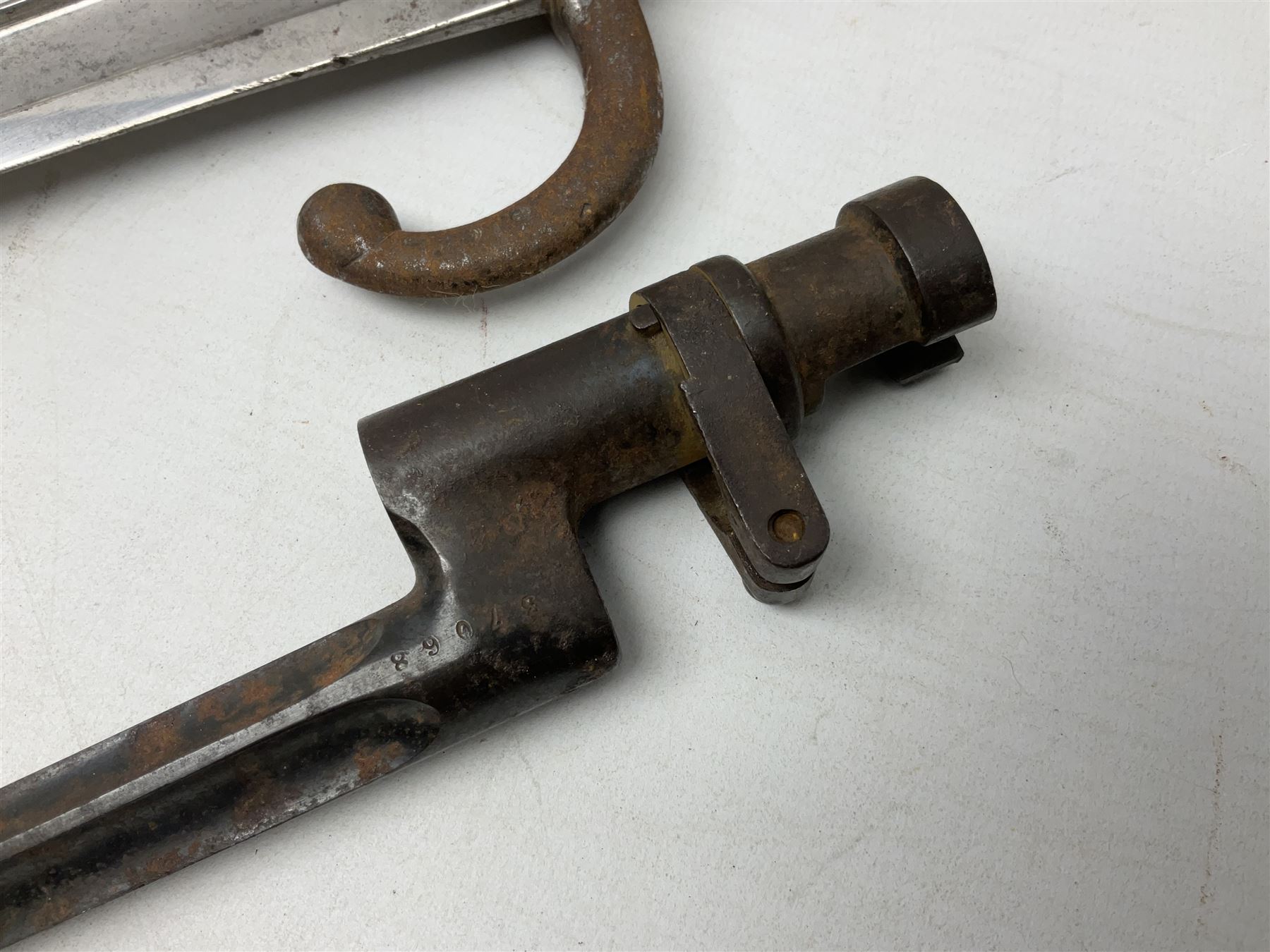 French model 1866 sabre bayonet, the 57.5cm curving blade marked St. Etienne 1873; in associated steel scabbard L71cm; and Mosin-Nagant M1891 socket bayonet with 43cm cruciform blade No.37068 (no scabbard) (2)