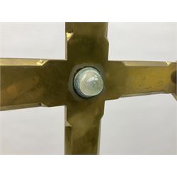 Brass alter cross, decorated with glass cabochons, upon a acicular stepped base and three claw feet, H73cm 