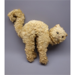 Merrythought plush covered straw filled cat in a startled pose with arched back and curled tail, inset glass eyes and stitched label to paw H42cm  