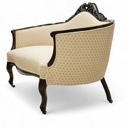Victorian mahogany upholstered settee, the shaped back with pierced foliate carved cresting, upholstered in cream patterned fabric with serpentine seat, on cabriole front legs with brass castors