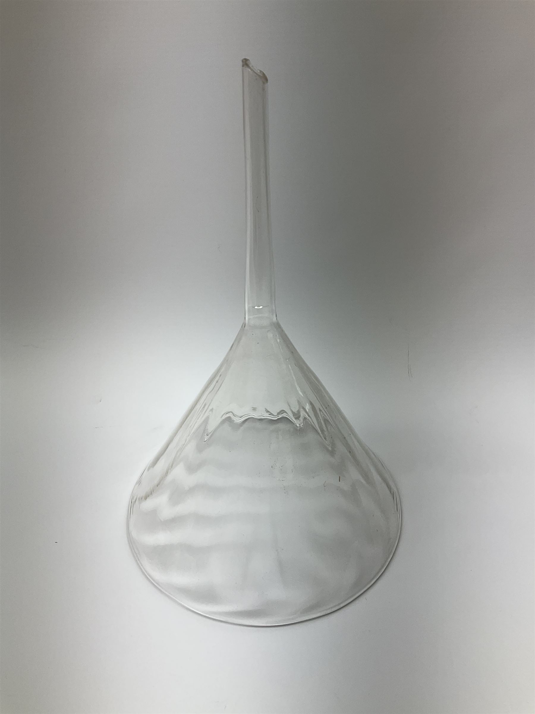 Collection of 19th century and later pharmaceutical laboratory glass, to include, large filter funnel, graham condenser, conical flask, bell jar and another with graduated tube, Provenance: discovered in the storeroom of a long established Hull pharmacist and opticians