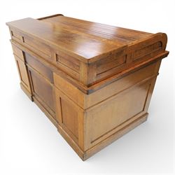 Globe Wernicke - Oak roll top desk, fitted with nine drawers, oak tambour roll top revealing a fitted interior, with single frieze drawer, flanked by four drawers to each pedestal, on a plinth base