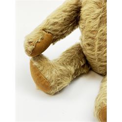 Rare early 20th century teddy bear c1920, possibly Chiltern/Einco or Harwin, mohair covered with wood wool filled humped back body with jointed limbs, cotton twill paw pads and vertically stitched nose with unusual W-shaped stitched mouth H15