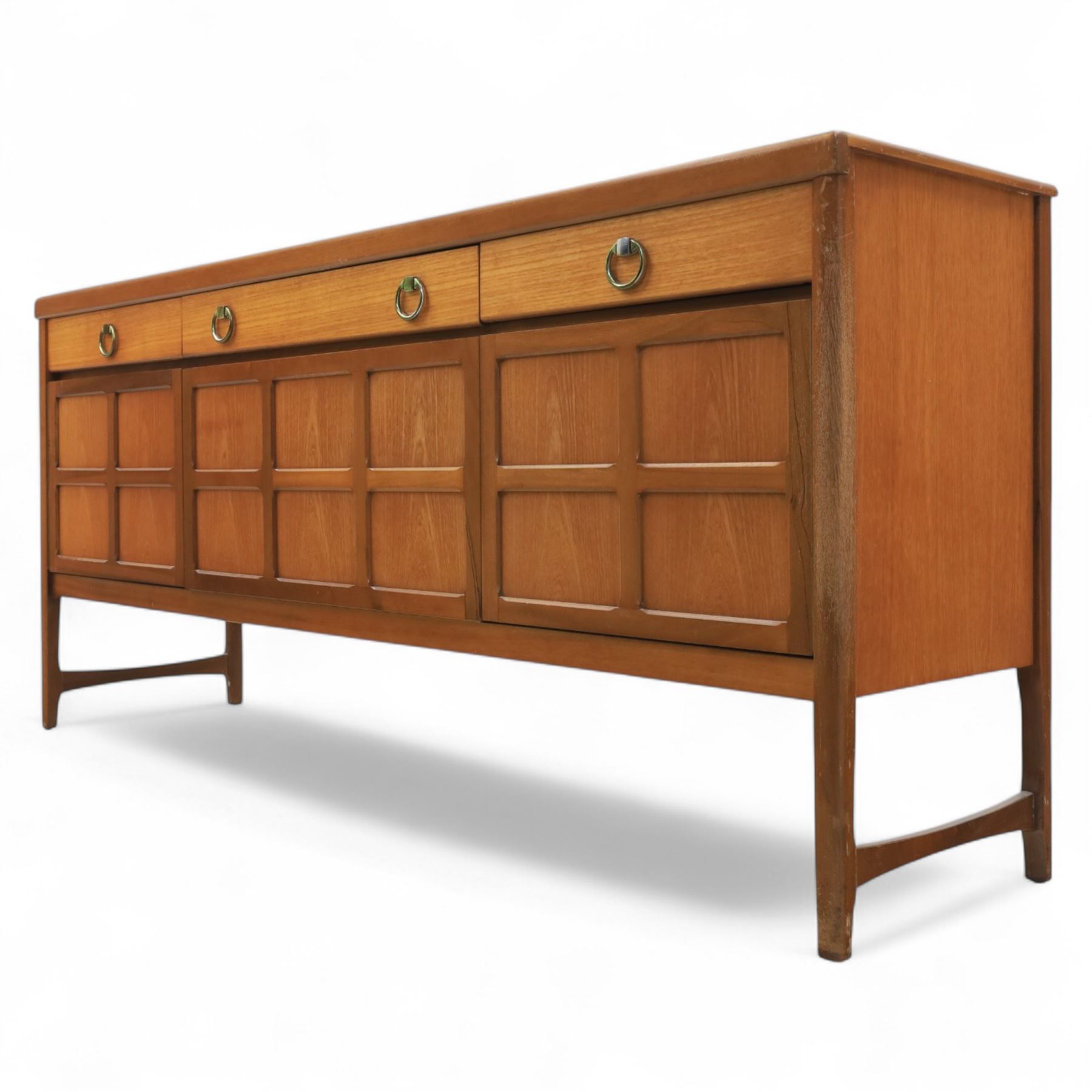 Nathan - mid 20th century teak sideboard, fitted with three drawers with brass ring handles, above a central fall front cabinet, flanked by two cupboard doors, raised on square tapering supports